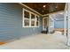 The home's covered patio is framed by dark wood and ample seating and lighting at 149 Shady Cove Rd, Troutman, NC 28166