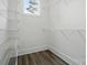 A bright walk-in closet with adjustable shelving, laminate flooring, and one window at 149 Shady Cove Rd, Troutman, NC 28166