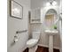 Well-lit half bathroom featuring a pedestal sink, modern fixtures, and a framed art piece at 1507 Arcadia Bluff Dr, York, SC 29745