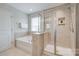Bathroom features a separate tub and tiled shower with glass door at 1507 Arcadia Bluff Dr, York, SC 29745