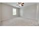 Spacious bedroom with neutral paint, ceiling fan, and large window at 1507 Arcadia Bluff Dr, York, SC 29745