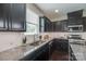 Beautiful kitchen featuring dark cabinets, granite countertops, stainless steel appliances, and natural light at 1507 Arcadia Bluff Dr, York, SC 29745