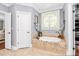 Bathroom with a soaking tub and a decorative window above it at 162 Kenway Loop, Mooresville, NC 28117