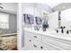 Bathroom featuring double sinks, white cabinets, and a view into an adjoining bedroom at 162 Kenway Loop, Mooresville, NC 28117