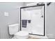Bathroom with glass-enclosed shower, gray walls, and tile floors at 162 Kenway Loop, Mooresville, NC 28117