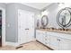 Bathroom featuring double sinks with granite countertop, vanity, and framed mirrors at 162 Kenway Loop, Mooresville, NC 28117