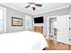 Bedroom featuring hardwood floors, neutral walls, ceiling fan, and ensuite bathroom at 162 Kenway Loop, Mooresville, NC 28117