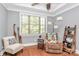 Relaxing bedroom features a reading nook with a comfortable chair and plenty of natural light from the large window at 162 Kenway Loop, Mooresville, NC 28117