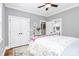 Bedroom with hardwood floors, gray walls, ceiling fan, and ensuite bathroom at 162 Kenway Loop, Mooresville, NC 28117