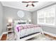 Bedroom with hardwood floors, gray walls, ceiling fan, and comfortable furniture at 162 Kenway Loop, Mooresville, NC 28117