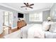 Bedroom with hardwood floors, gray walls, ceiling fan, and comfortable furniture at 162 Kenway Loop, Mooresville, NC 28117