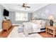 Bedroom with hardwood floors, gray walls, ceiling fan, and comfortable furniture at 162 Kenway Loop, Mooresville, NC 28117