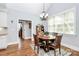 Eat-in dining area with a window, hardwood floors, chandelier, and table with seating at 162 Kenway Loop, Mooresville, NC 28117