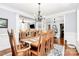 Open dining room showcases hardwood floors and views into the living area and foyer at 162 Kenway Loop, Mooresville, NC 28117