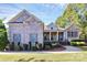 Charming brick home features mature landscaping, two-car garage and inviting front porch at 162 Kenway Loop, Mooresville, NC 28117