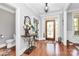 Inviting home foyer features a decorative glass front door, elegant chandelier, and hardwood flooring at 162 Kenway Loop, Mooresville, NC 28117