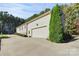 Spacious two-car garage with large driveway and well-maintained landscaping at 162 Kenway Loop, Mooresville, NC 28117