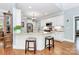 Bright open concept kitchen with an island, seating, stainless appliances and granite countertops at 162 Kenway Loop, Mooresville, NC 28117