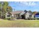 Well maintained rear exterior features manicured lawn and tasteful landscaping at 162 Kenway Loop, Mooresville, NC 28117