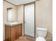 Neat bathroom with wood vanity, sink, and a toilet creating a functional and tidy space at 1785 Doe Ct, Iron Station, NC 28080