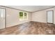 Spacious bedroom with natural light, two windows, and modern wood-look floors for a comfortable retreat at 1785 Doe Ct, Iron Station, NC 28080