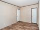 A clean, minimalist bedroom featuring neutral walls, white doors, and wood-look flooring for a warm, inviting space at 1785 Doe Ct, Iron Station, NC 28080