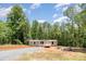 New home exterior with gravel driveway at 1785 Doe Ct, Iron Station, NC 28080
