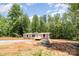 New home exterior with gravel driveway at 1785 Doe Ct, Iron Station, NC 28080