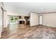 Bright living room flows into kitchen with modern appliances and sliding doors at 1785 Doe Ct, Iron Station, NC 28080