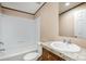A bathroom featuring a white tub, matching toilet, and a vanity with a granite-look countertop at 1785 Doe Ct, Iron Station, NC 28080