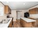 A kitchen featuring wooden cabinets, granite-look countertops, and modern black appliances at 1785 Doe Ct, Iron Station, NC 28080