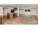 A open concept kitchen and living space with an island, great flooring, and neutral paint at 1785 Doe Ct, Iron Station, NC 28080