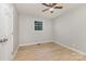 Bright bedroom features wood-look flooring, a ceiling fan, and a window for natural light at 1874 Sunny Ln, Lancaster, SC 29720