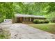 Well-maintained brick home with a long driveway and charming curb appeal surrounded by greenery at 1874 Sunny Ln, Lancaster, SC 29720