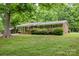 Beautiful brick home with lush green lawn and mature trees providing shade and curb appeal at 1874 Sunny Ln, Lancaster, SC 29720