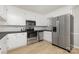 Modern kitchen featuring stainless steel appliances, white cabinets, and wood-look floors at 1874 Sunny Ln, Lancaster, SC 29720
