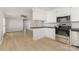Modern open-concept kitchen with stainless steel appliances and a breakfast bar overlooking the living area at 1874 Sunny Ln, Lancaster, SC 29720