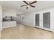 Open-concept living area with wood-look floors, white trim and bright, natural lighting at 1874 Sunny Ln, Lancaster, SC 29720