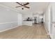 Bright, open living area leading into a modern kitchen with stainless steel appliances at 1874 Sunny Ln, Lancaster, SC 29720
