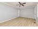 Spacious living room with wood-look floors, neutral walls, a ceiling fan and an entry door at 1874 Sunny Ln, Lancaster, SC 29720
