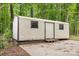 Exterior view of shed set among trees in a spacious backyard at 1874 Sunny Ln, Lancaster, SC 29720