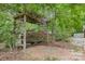 Cozy swing under a pergola in a beautiful wooded backyard setting at 1874 Sunny Ln, Lancaster, SC 29720