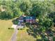 Aerial shot of the home with a large lot, mature trees, and an attached two-car garage at 2240 Armstrong Park Dr, Gastonia, NC 28054
