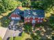 Aerial view of the home with a two-car garage, set back on a well-maintained lot with mature trees at 2240 Armstrong Park Dr, Gastonia, NC 28054