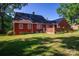 View of the home's backyard with a brick patio area and well maintained lawn at 2240 Armstrong Park Dr, Gastonia, NC 28054