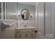 Bathroom with single sink vanity, tile walls, and gold light fixtures at 2240 Armstrong Park Dr, Gastonia, NC 28054
