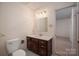 Bathroom featuring a vanity with a mirror, toilet, and a view into another room at 2240 Armstrong Park Dr, Gastonia, NC 28054