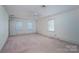 Large bedroom featuring carpet, neutral walls, several windows, and a ceiling fan at 2240 Armstrong Park Dr, Gastonia, NC 28054