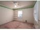 Bedroom featuring carpet, neutral walls, a ceiling fan, green accents, and shelving at 2240 Armstrong Park Dr, Gastonia, NC 28054