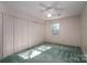 Bright bedroom featuring light green carpet, neutral walls, ceiling fan, and double closets at 2240 Armstrong Park Dr, Gastonia, NC 28054